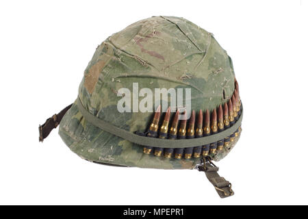 US Army helmet with camouflage cover and ammo belt - Vietnam war period isolated Stock Photo