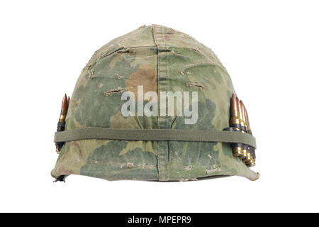 US Army helmet with camouflage cover and ammo belt - Vietnam war period isolated Stock Photo