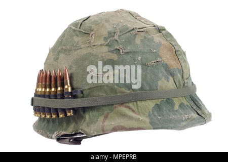 US Army helmet with camouflage cover and ammo belt - Vietnam war period isolated Stock Photo