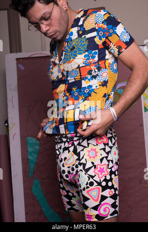 Man getting dressed in bright clothing. Stock Photo