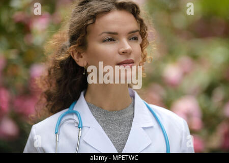 Portrait of a young woman doctor, medical practitioner with an aspiring thoughtful look, career in natural medicine, healthcare as a physician. The wo Stock Photo