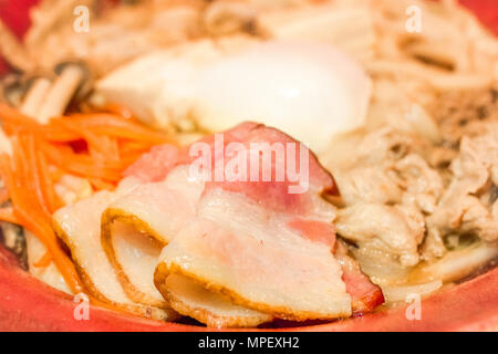 Japanese food. Udon noodles with bacon, sliced pork, egg bael,carrots and mushroom.Closed up.Copy space.(Soft focus) Stock Photo