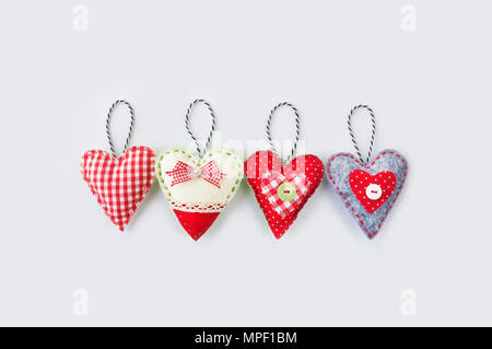 Two hand made textile hearts.  Textile handicraft on a white background. Valentines Day, Wedding composition with hearts. Stock Photo