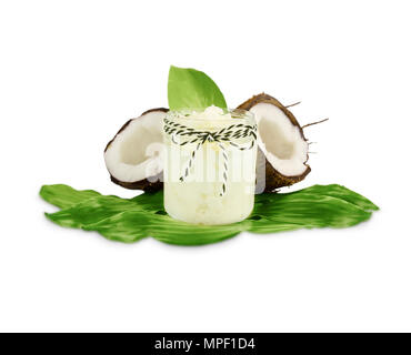 Jar of coconut oil and fresh coconuts isolated on white background. Coconut nuts with leaves. Stock Photo