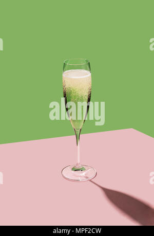 A flute filled with Prosecco, an italian white sparkling wine cultivated in Valdobbiadene. Pop colorful background Stock Photo