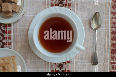 cup with tea on a beautiful tablecloth top view Stock Photo