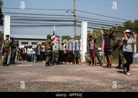 Royal Thai and Malaysian service members search evacuee role players as they enter an evacuation control center during a non-combatant evacuation operation exercise during Cobra Gold 2017 at Utapao International Airport in Rayong Province, Thailand, Feb. 19, 2017. Cobra Gold, in its 36th iteration, focuses on humanitarian civic action, community engagement, and medical activities to support the needs and humanitarian interest of civilian populations around the region. (U.S. Marine Corps photo by Lance Cpl. Daniel R. Betancourt Jr.) Stock Photo