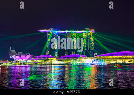 Singapore - April 27, 2018: great laser show at night time at Marina Bay Sands Hotel and Casino and ArtScience Museum. Laser lights on the waters of Marina Bay Waterfront promenade in Singapore. Stock Photo