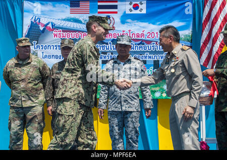 RAYONG PROVINCE, Thailand (Feb. 21, 2017) – Lt. Nicholas Peskosky, officer-in-charge of the Ban Nong Muang expansion project, assigned to Naval Mobile Construction Battalion Five, shakes hands with Gov. Surasak Charoensirichot, Rayong provincial governor during a dedication ceremony, marking the completion of the Ban Nong Muang school expansion project. The project was a joint effort by the U.S. Naval Mobile Construction Battalion 5, Construction and Developmental Regiment, Sattahip Naval Base and Korean Naval Mobile Construction Battalion 2nd Engineer, part of Cobra Gold 2017. Cobra Gold, in  Stock Photo