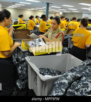 170217-N-SL853-066  GREAT LAKES, Ill. (Feb. 17, 2017) Logistics Specialist 1st Class Amber Wilson, the Sailor of the Year, inspects her recruits' uniforms from Division 120 for proper wear and fitting at their first uniform issue during in-processing days at Recruit Training Command. About 30,000-40,000 recruits graduate annually from the Navy's only boot camp. (U.S. Navy photo by Chief Petty Officer Seth Schaeffer/Released) Stock Photo