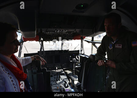 Lt. Col. Adam Wiggins, Rhode Island Air National Guard C-130J Super Herculesmission commander, briefs MaryKay Carlson, Charge d'Affaires of the U.S. Mission to India, on the opening day of Aero India 2017 at Air Force Station Yelahanka, India Feb. 14, 2017. The United States maintained a robust presence at the air and trade show, with a delegation led by the Department of State and Department of Defense as well as a strong contingent of officials from other prominent federal offices for the 11th iteration of the air show. The United States participates in air shows and other regional events to Stock Photo