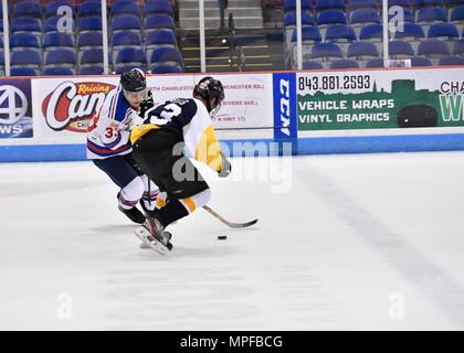 Members of the Charleston Patriots and the Charleston Enforcers play hockey during the 3rd Annual Matuskovic Charity Hockey Game at the North Charleston Coliseum & Performing Arts Center, Feb. 18, 2017. The game is played in memory of Joe Matuskovic, Charleston County Sherriff’s deputy, and other service members and first responders killed in the line of duty. Members of the Charleston Patriots are from Joint Base Charleston while members of the Charleston Enforcers are from the Charleston County Sheriff’s office and fire department.The Charleston Enforcers won the game with a final score of 1 Stock Photo