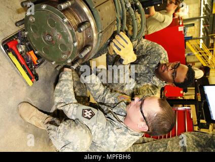 Spc. Christopher Norwood with the 275th Quartermaster Company at Fort Pickett, Va., and Sgt. Marquett Evans with the 422nd Civil Affairs Battalion at Greensboro, N.C., both students at Regional Training Site-Maintenance in the Wheeled Vehicle Mechanics Course, work on a project Feb. 10, 2017, at Fort McCoy. During the course, students learn to complete all basic concepts required to be certified as an Army wheeled-vehicle mechanic. This includes performing field-level maintenance on automotive wheeled vehicles and conducting wheeled-vehicle operations; receiving an introduction to troubleshoot Stock Photo