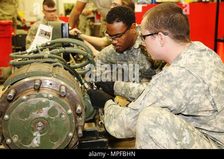 Spc. Christopher Norwood with the 275th Quartermaster Company at Fort Pickett, Va., and Sgt. Marquett Evans with the 422nd Civil Affairs Battalion at Greensboro, N.C., both students at Regional Training Site-Maintenance in the Wheeled Vehicle Mechanics Course, work on a project Feb. 10, 2017, at Fort McCoy. During the course, students learn to complete all basic concepts required to be certified as an Army wheeled-vehicle mechanic. This includes performing field-level maintenance on automotive wheeled vehicles and conducting wheeled-vehicle operations; receiving an introduction to troubleshoot Stock Photo