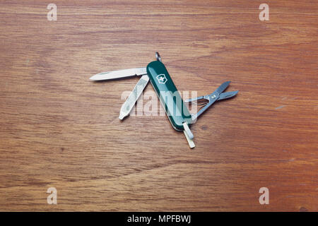 Victorinox Classic SD pocket knife, 6 tools, on wooden background, flat lay Stock Photo