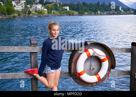 Geneve Lake Leman sister kid girl friends lifebuoy  in Switzerland Swiss Stock Photo