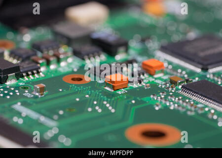 Laptop motherboard closeup. Printed circuit Board with SMD capacitors, resistors, diodes and chips. Stock Photo