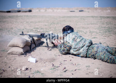 A local female Manbij Military Council trainee fires a 7.62mm PK machine gun during marksmanship training Feb. 21, 2017, at Sanaa Training Center in Northwest Syria. The instruction is 20 days long to include basic rifle marksmanship, and squad level weapons and movement techniques. This is the first cycle of women to graduate and join the MMC. The course is administered by Special Operations Joint Task Force – Operation Inherent Resolve trainers. (U.S. Army photo by Master Sgt. Mark Burrell, CJTF-OIR) Stock Photo