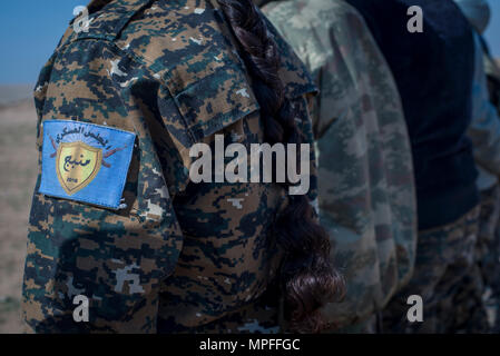 Local female Manbij Military Council trainees learn marksmanship training Feb. 21, 2017, at Sanaa Training Center in Northwest Syria. The blue patch is the logo of the MMC which protects Manbij. The MMC is a multi-ethnic force that includes Kurds, Arabs, Christians, Turkmen, Yazidis and others. This is the first cycle of women to graduate and join the MMC. The course is administered by Special Operations Joint Task Force – Operation Inherent Resolve trainers. (U.S. Army photo by Master Sgt. Mark Burrell) Stock Photo