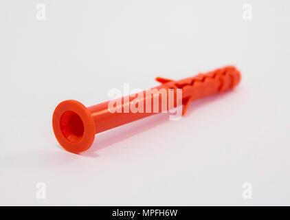 One plastic orange dowel on white background Stock Photo