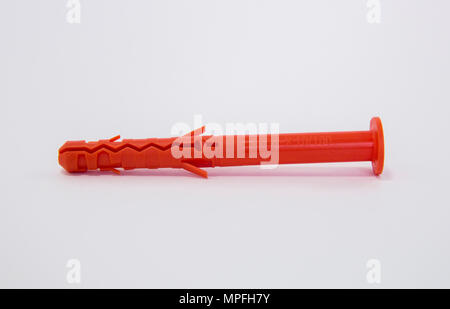 One plastic orange dowel on white background Stock Photo