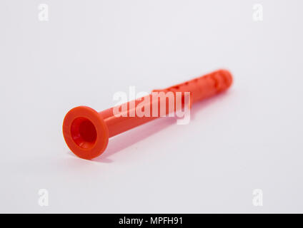 One plastic orange dowel on white background Stock Photo