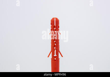 One plastic orange dowel on white background Stock Photo