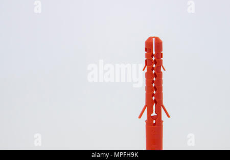 One plastic orange dowel on white background Stock Photo