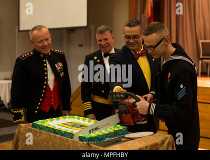 SASEBO, Japan (Mar. 4, 2017) The youngest and oldest Seabees present, Utilitiesman Constructionman Wyatt Hales and Jaime Rios, cut the cake during the 75th Seabee Ball aboard Commander, U.S. Fleet Activies Sasebo Mar. 4, 2017. The ball was held to commemorate the 75th Anniversary of the U.S. Navy Seabees, 150th Anniversary of the Civil Engineer Corps, and the 175th Anniversary of Naval Facilities Engineering Command. (U.S. Navy photo by Mass Communication Specialist Seaman Geoffrey P. Barham/Released) Stock Photo