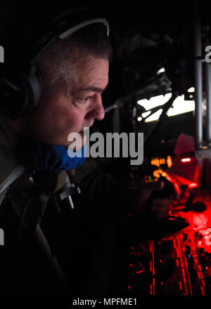 U.S. Air Force Tech Sgt. Mark Perkins, a boom operator with the 121st Air Refueling Wing, Ohio Air National Guard prepares to refuel an MC-130J Commando II with the 9th Special Operations Squadron during a training sortie in support of Emerald Warrior 17 March 7, 2017. Emerald Warrior is a U.S. Special Operations Command exercise during which joint special operations forces train to respond to various threats across the spectrum of conflict. (U.S. Air National Guard photo by Senior Airman Ashley Williams) Stock Photo