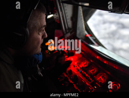 U.S. Air Force Tech Sgt. Mark Perkins, a boom operator with the 121st Air Refueling Wing, Ohio Air National Guard prepares to refuel an MC-130J Commando II with the 9th Special Operations Squadron during a training sortie in support of Emerald Warrior 17 March 7, 2017. Emerald Warrior is a U.S. Special Operations Command exercise during which joint special operations forces train to respond to various threats across the spectrum of conflict. (U.S. Air National Guard photo by Senior Airman Ashley Williams) Stock Photo