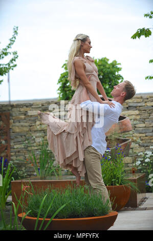 Dancers performing in the Silent Pool Gin Garden (designed by David Neale), one of the beautiful and elegant show gardens on display at the 2018 RHS Chelsea Flower Show which opened today in the 11-acre grounds of the Royal Hospital Chelsea, London, United Kingdom.  The professional dancers are Camilla Rowland and Austin Wilks.  The Silent Pool Gin Garden’ is intended for a professional couple who live in the city and require a space to escape to and unwind from their busy lives. Key features include native multi-stemmed Crataegus monogyna, a contemporary water feature with an infinity edge, a Stock Photo