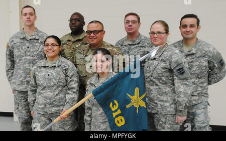Forest Park, Ill. - Spc. Nathan Mach, Spc. Christopher Madkins, Sgt. 1st Class Darrin McDufford, and Sgt. Alfonso Corral (back row); Spc. Alejandra Duenas, Spc. Nicole Nicolas, and Spc. Jacquelyn Mathieu (front row) of the 318th Press Camp Headquarters located at Forest Park, Ill. pose with Brig. Gen. Jose Burgos of the 99th Regional Support Command after the Change of Command ceremony on March 11, 2017. (US Army photo by Spc. Gail Sanders.) Stock Photo