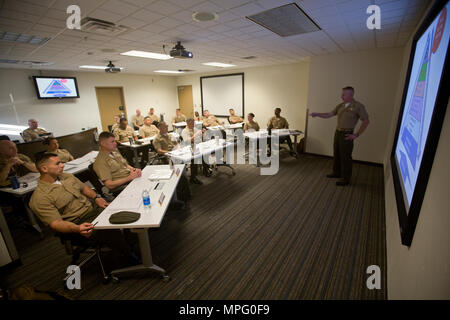 U.S. Marine Capt. Scott L. Campbell, maintenance officer with Marine Aviation Weapons and Tactics Squadron One (MAWTS-1) welcomes students attending the first ever Advanced Aircraft Maintenance Officer Course (AAMOC) at Marine Corps Air Station Yuma, Ariz., on Mar. 13, 2017. AAMOC will empower Aircraft Maintenance Officers with leadership tools, greater technical knowledge, and standardized practices through rigorous academics and hands on training in order to decrease ground related mishaps and increase sortie generation. (U.S. Marine Corps photo taken by Cpl. AaronJames B. Vinculado)