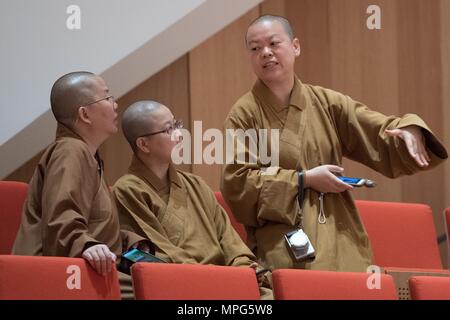 23 May 2018, Germany, Dresden: Buddhist nuns attend a rehearsal of 'Buddha Passion' at the Kulturpalast. Musicians of the Munich Philharmonics and singers of the International Choir Academy Luebeck perform the piece. Photo: Sebastian Kahnert/dpa Stock Photo