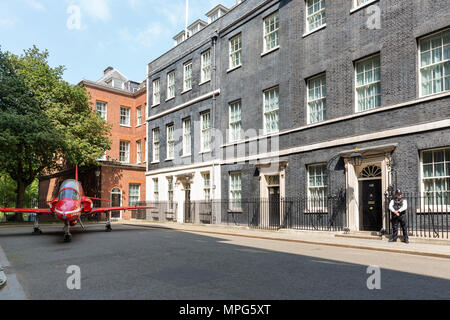 Downing Street, London, UK. 23rd May, 2018. A Red Arrow jet parked outside Number 10 Downing St, London, UK, to mark 100 years of the RAF (Royal Air Force) MUST CREDIT: Chris Aubrey/Alamy Live News Stock Photo