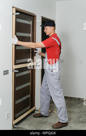 Installing door unit. Workman puting it into place. Stock Photo