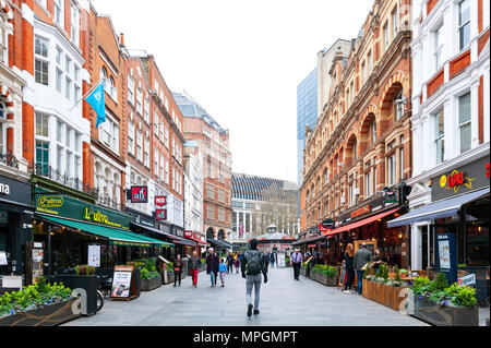 London, UK - April 2018: Shops and restaurants located along both sides of Irving Street at Leicester Square Stock Photo