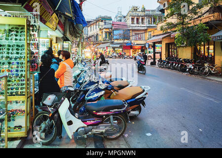 Hanoi, Vietnam - February 21, 2016: Scooters on busy street in Hanoi, Vietnam Stock Photo