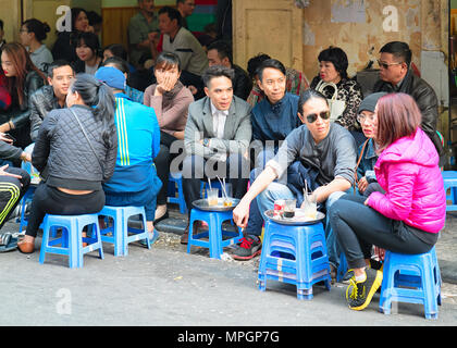 Hanoi, Vietnam - February 21, 2016: People having drinks at street cafe in Hanoi, Vietnam Stock Photo