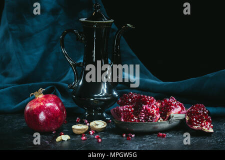 Black teapot and pomegranates  Stock Photo