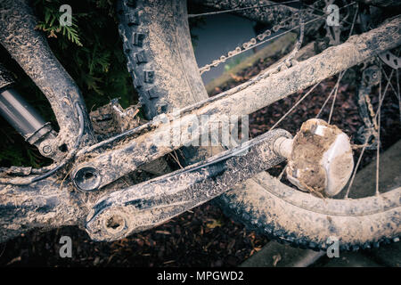 Mountain biking, dirty and broken bicycle closeup. MTB bicycle with mud and sand waiting for cleaning and repairing. Adventure and extreme enduro cycl Stock Photo