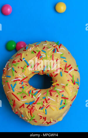 Round Donuts in the glaze on the blue background Stock Photo