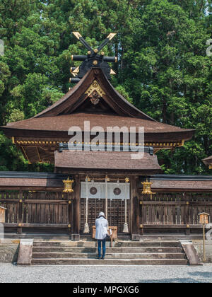 Woman praying at Honden, Kumano Hongu Taisha,  world heritage shrine, Wakayama Prefecture, Japan Stock Photo