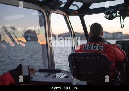 Petty Officer 3rd Class Bryan Freeman, a boatswain's mate from Coast Guard Station Manasquan Inlet, pilots a 29-foot Response Boat-Small during an evening patrol on Manasquan River, Feb 23, 2017. U.S. Coast Guard photo by Auxiliarist David Lau.