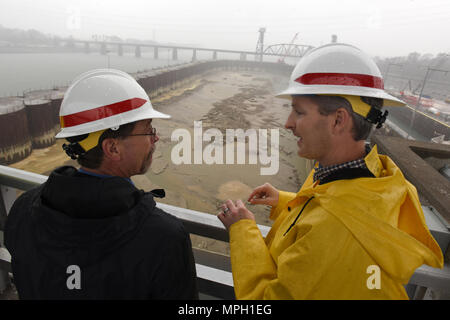 Adam Walker (Right), U.S. Army Corps of Engineers Nashville District project manager for the Chickamauga Lock Replacement Project, briefs Douglas Lamont, senior official performing duties of secretary of the Army for Civil Works, on the status of the work Feb. 28, 2017 in Chattanooga, Tenn. The Tennessee Valley Authority owns the dam while the Nashville District operates and maintains the current lock. (USACE photo by Leon Roberts) Stock Photo