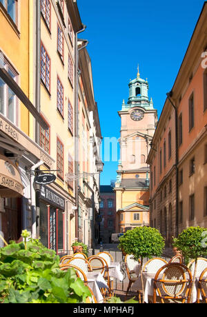 STOCKHOLM, SWEDEN - APRIL 14, 2010: Street cafe in Gamla Stan (Old Town) near Stortorget (Main Square). On the background is The Saint Nicolas Church Stock Photo