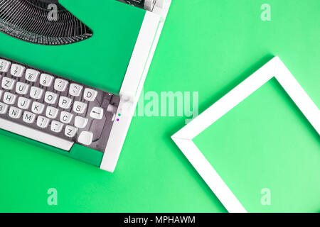 Retro vintage typewriter and photo frame green minimal creative concept. Stock Photo