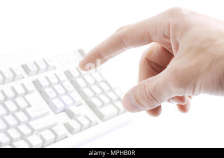 finger hit the button on the old computer keyboard Stock Photo