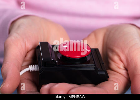 Close-up Of Woman Holding Personal Alarm On Her Hands Stock Photo